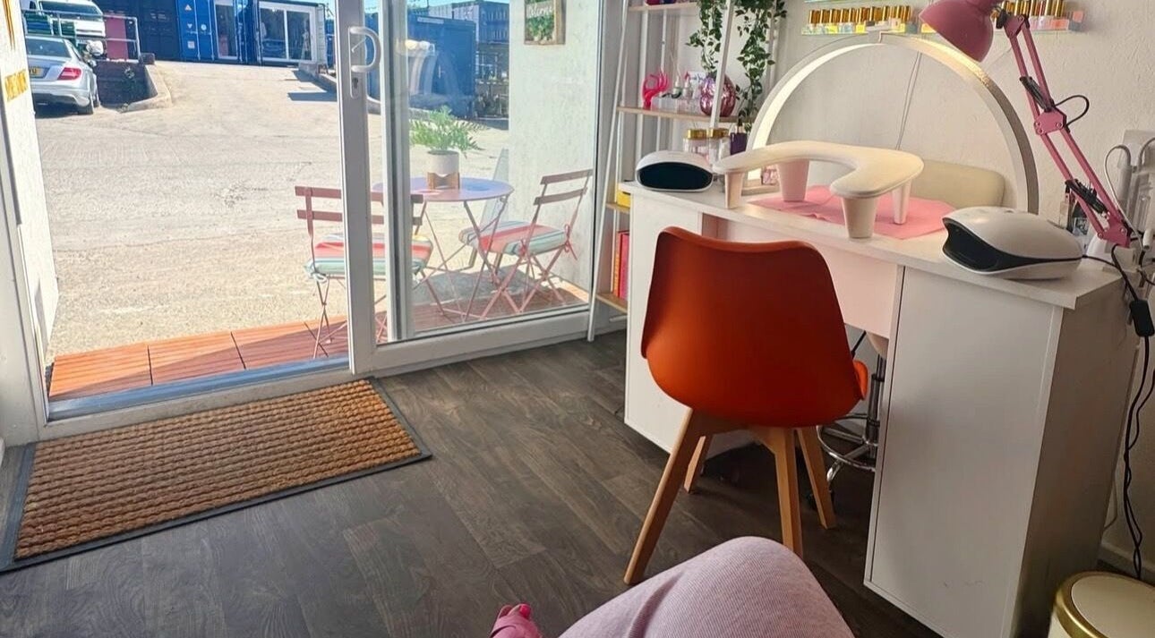 Bright interior of Nadette's Beauty Parlour, Manchester, England, GB, showcasing a stylish nail station.