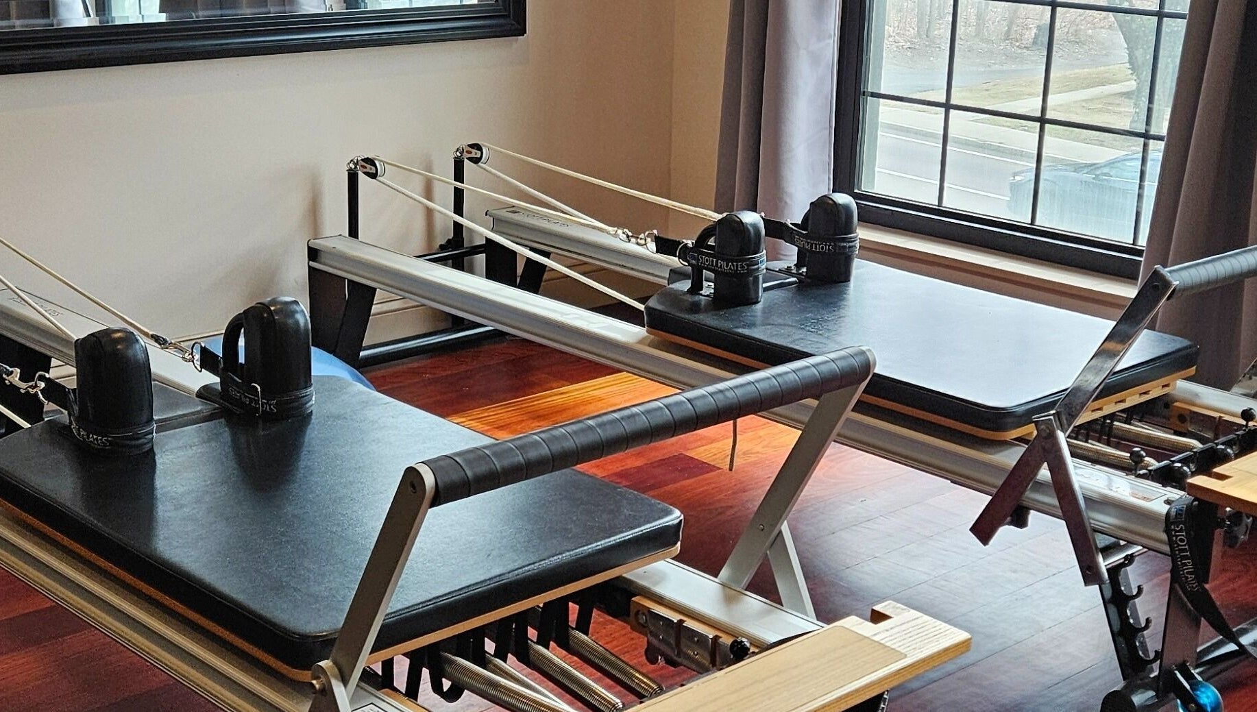 Reformer Pilates equipment at Joy Wellness for Life in Holbrook, Massachusetts, US, with sunlit room.