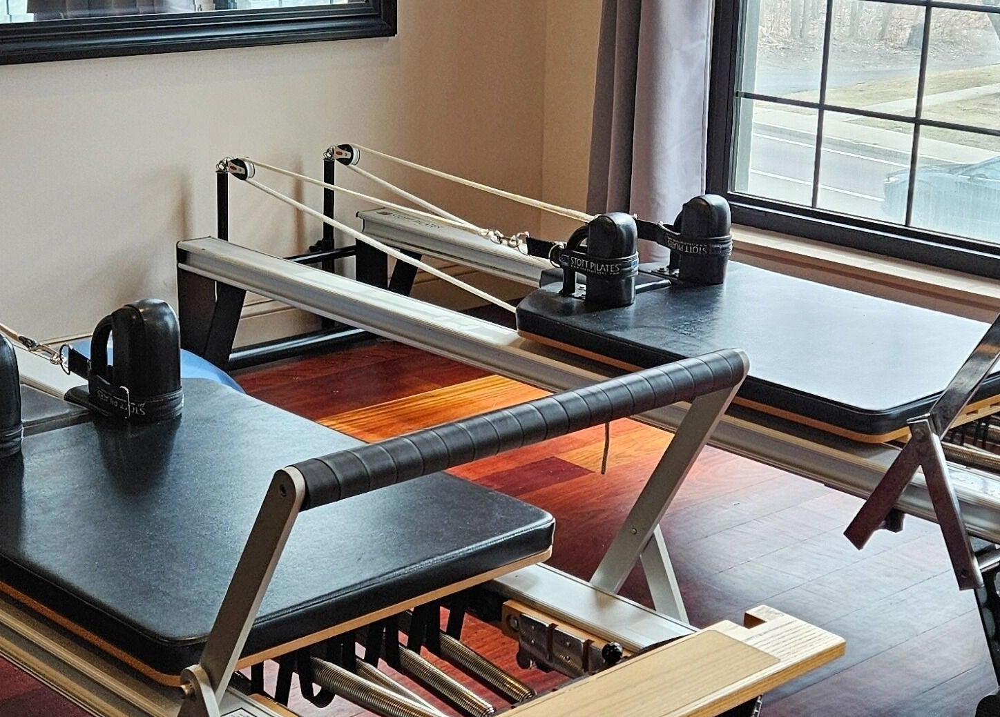 Reformer Pilates equipment at Joy Wellness for Life in Holbrook, Massachusetts, US, with sunlit room.