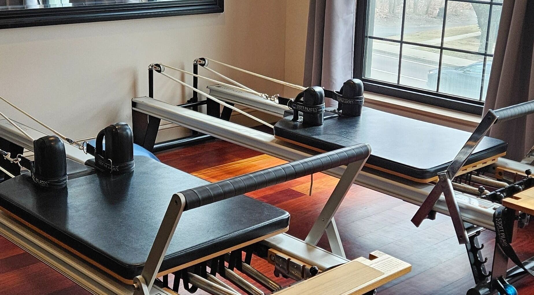Reformer Pilates equipment at Joy Wellness for Life in Holbrook, Massachusetts, US, with sunlit room.