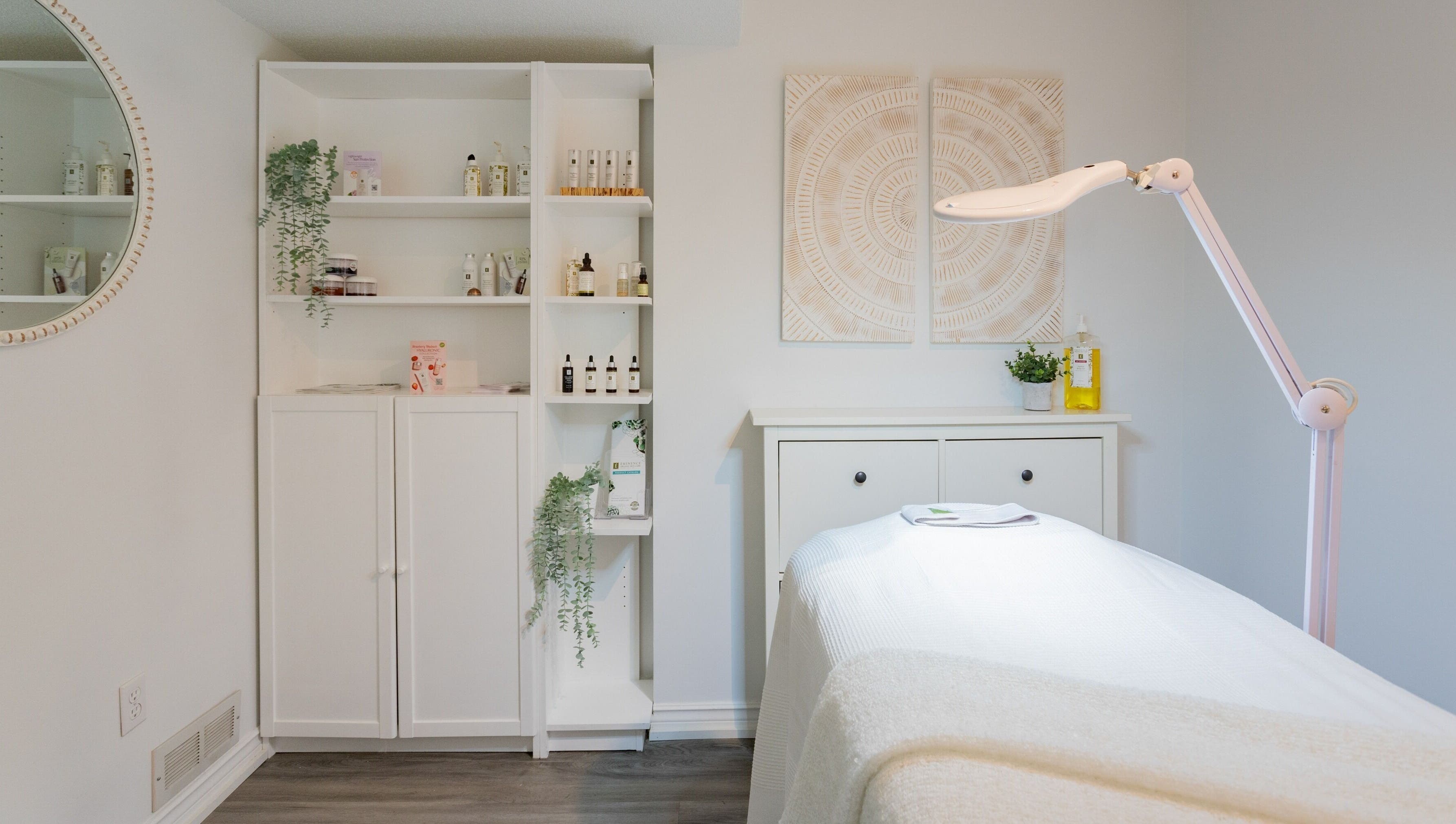 Treatment room at Derma Luxe laser and skin in Cambridge, Ontario, CA, featuring skincare products and ambient decor.