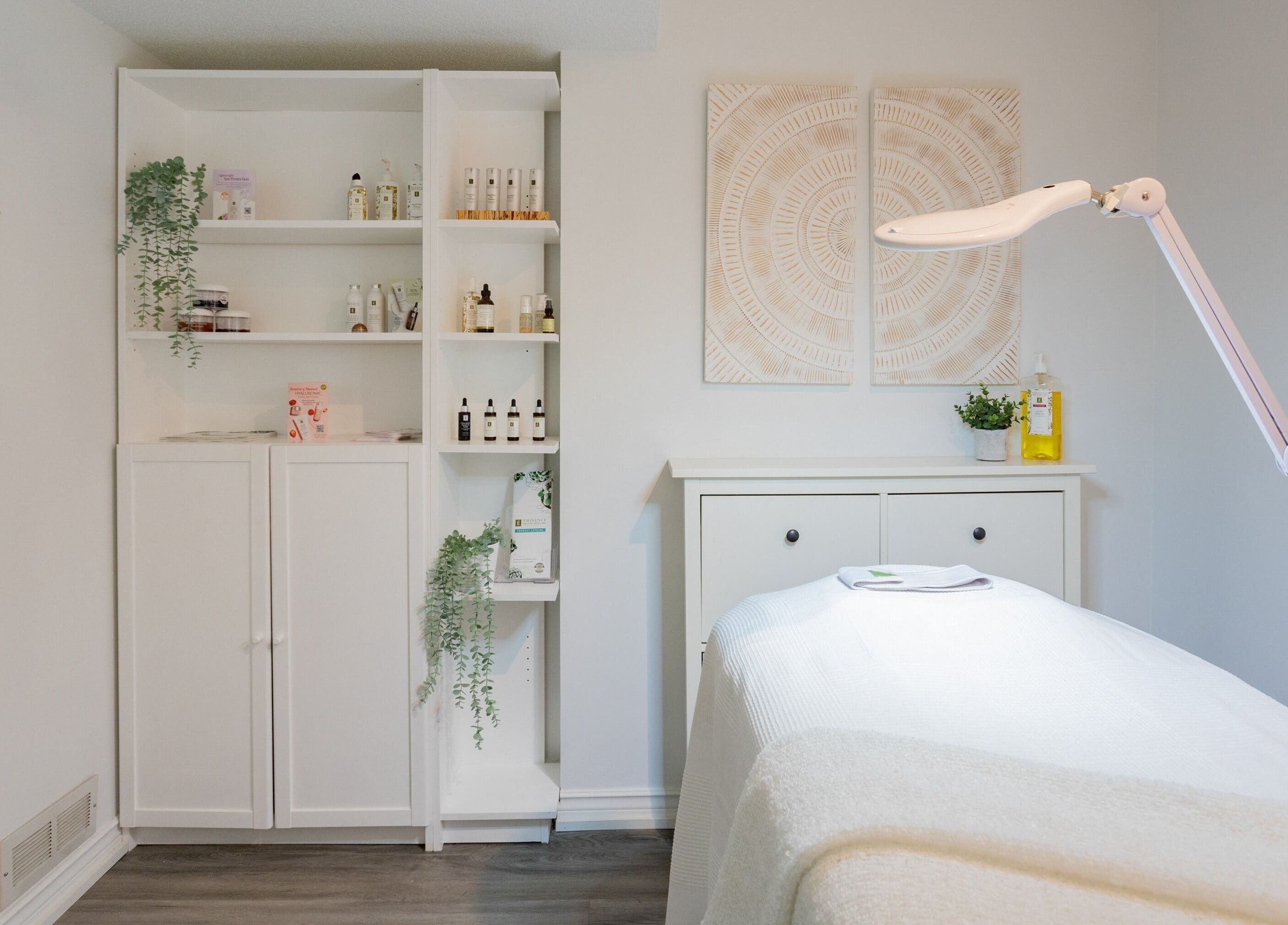 Treatment room at Derma Luxe laser and skin in Cambridge, Ontario, CA, featuring skincare products and ambient decor.