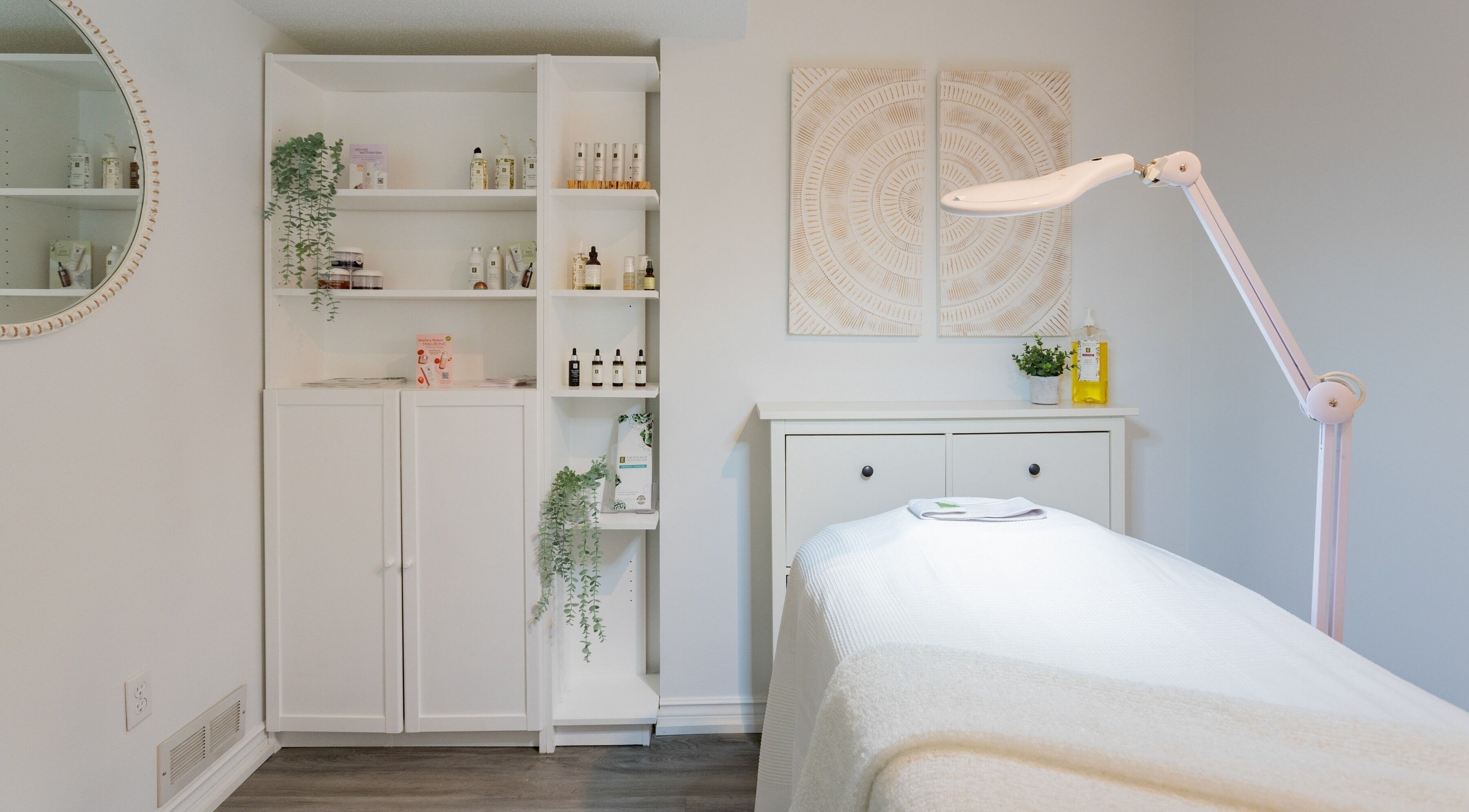 Treatment room at Derma Luxe laser and skin in Cambridge, Ontario, CA, featuring skincare products and ambient decor.