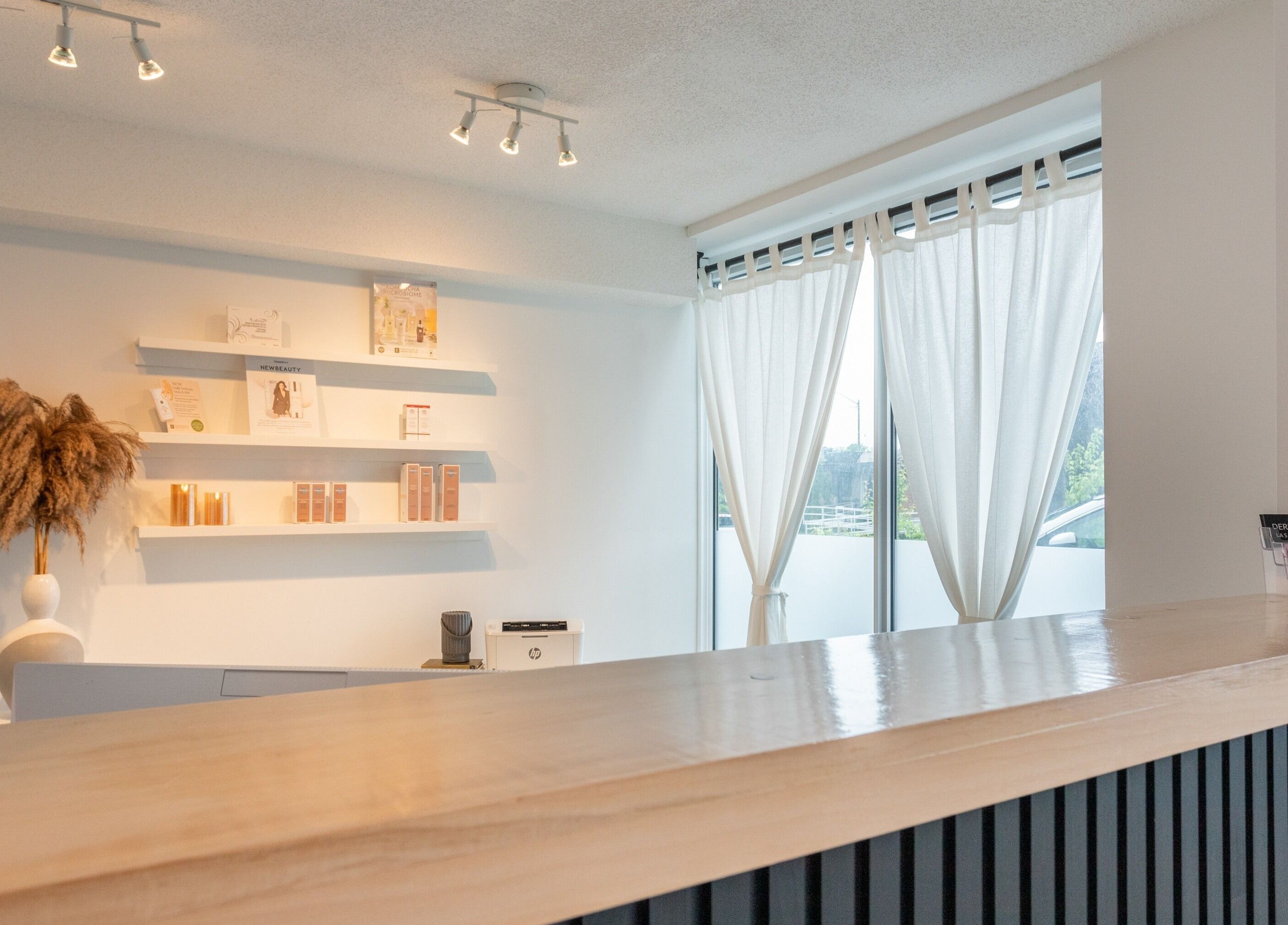 Reception area of Derma Luxe laser and skin in Cambridge, Ontario, CA with elegant decor and natural lighting.