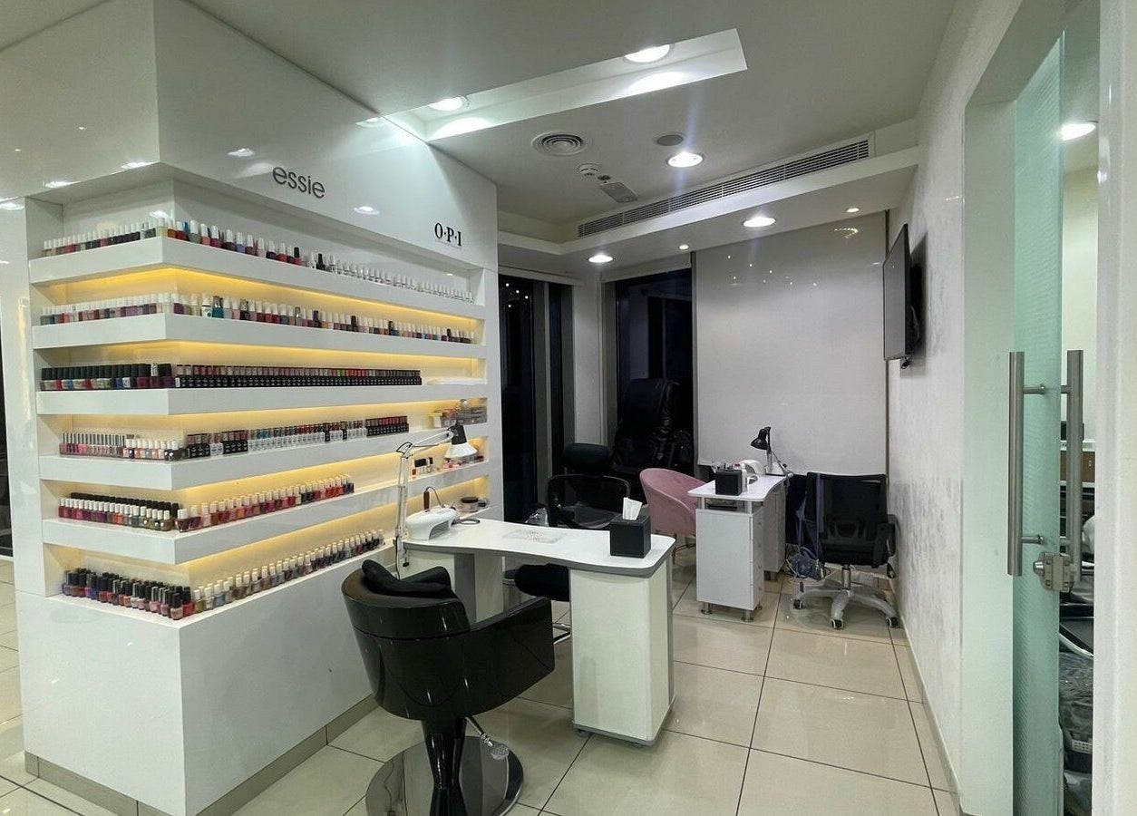 Modern nail area at Karim and Amin Salon, Dubai, Dubai, AE showcasing sleek design and nail polish display.