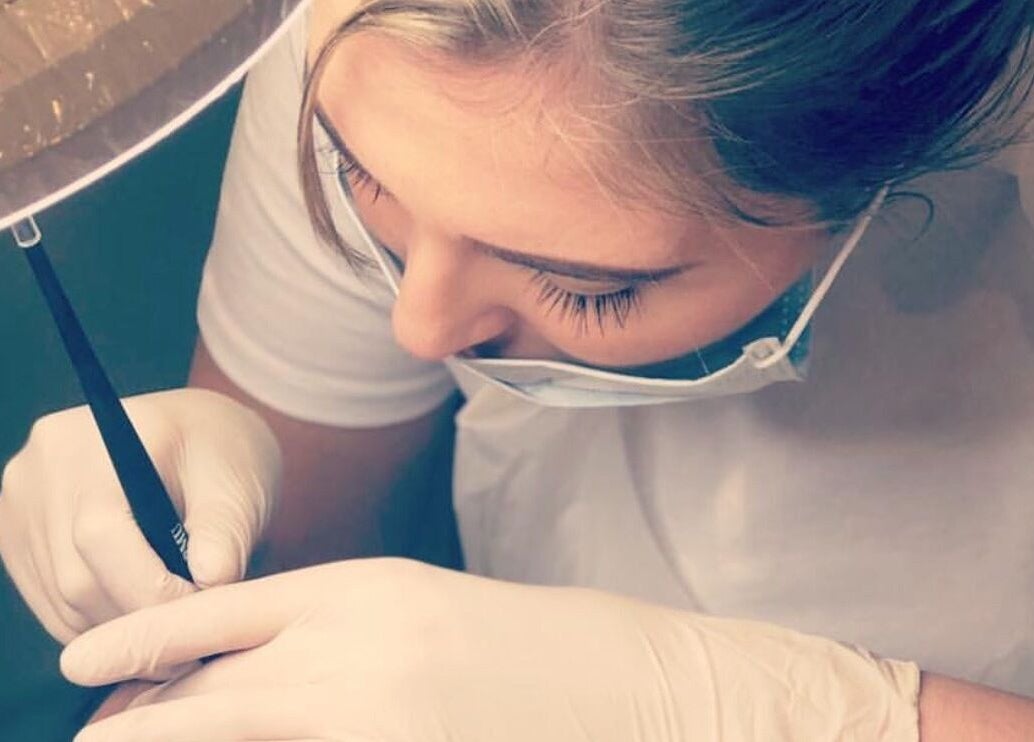 Artist at Blinx Brows by Ashton performing microblading in Rugby, England, GB. Precision in beauty techniques.