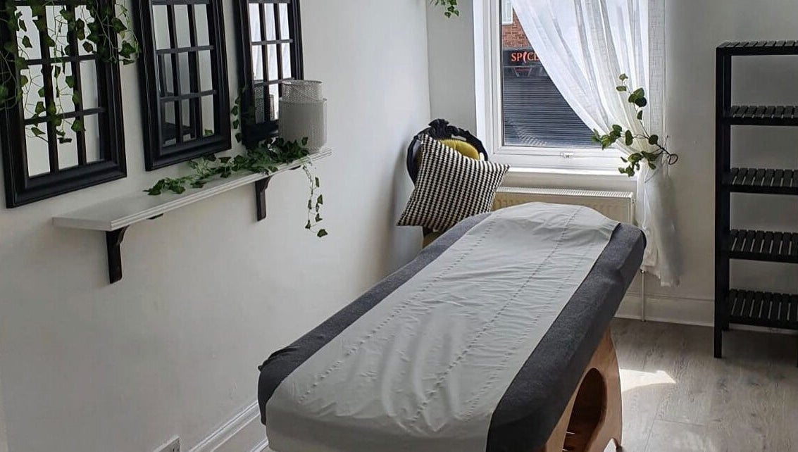 Relaxing treatment room at Halo Holistics at Perfection Lounge, Whiston, England, GB, featuring a massage table.