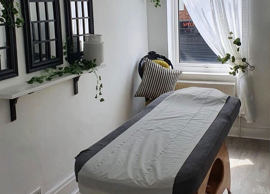 Relaxing treatment room at Halo Holistics at Perfection Lounge, Whiston, England, GB, featuring a massage table.