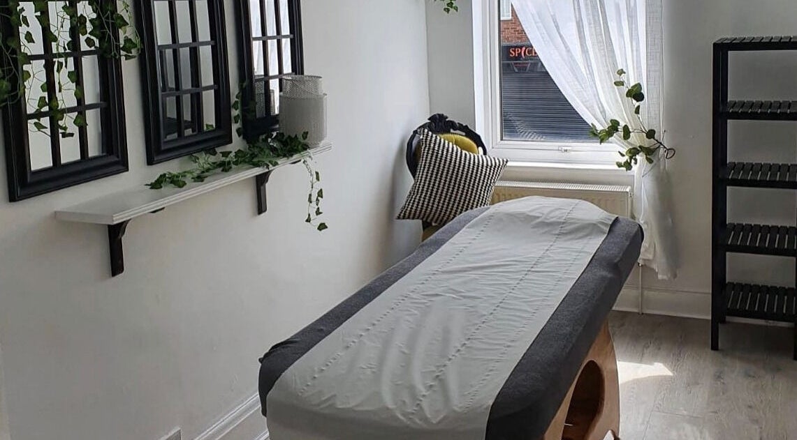 Relaxing treatment room at Halo Holistics at Perfection Lounge, Whiston, England, GB, featuring a massage table.