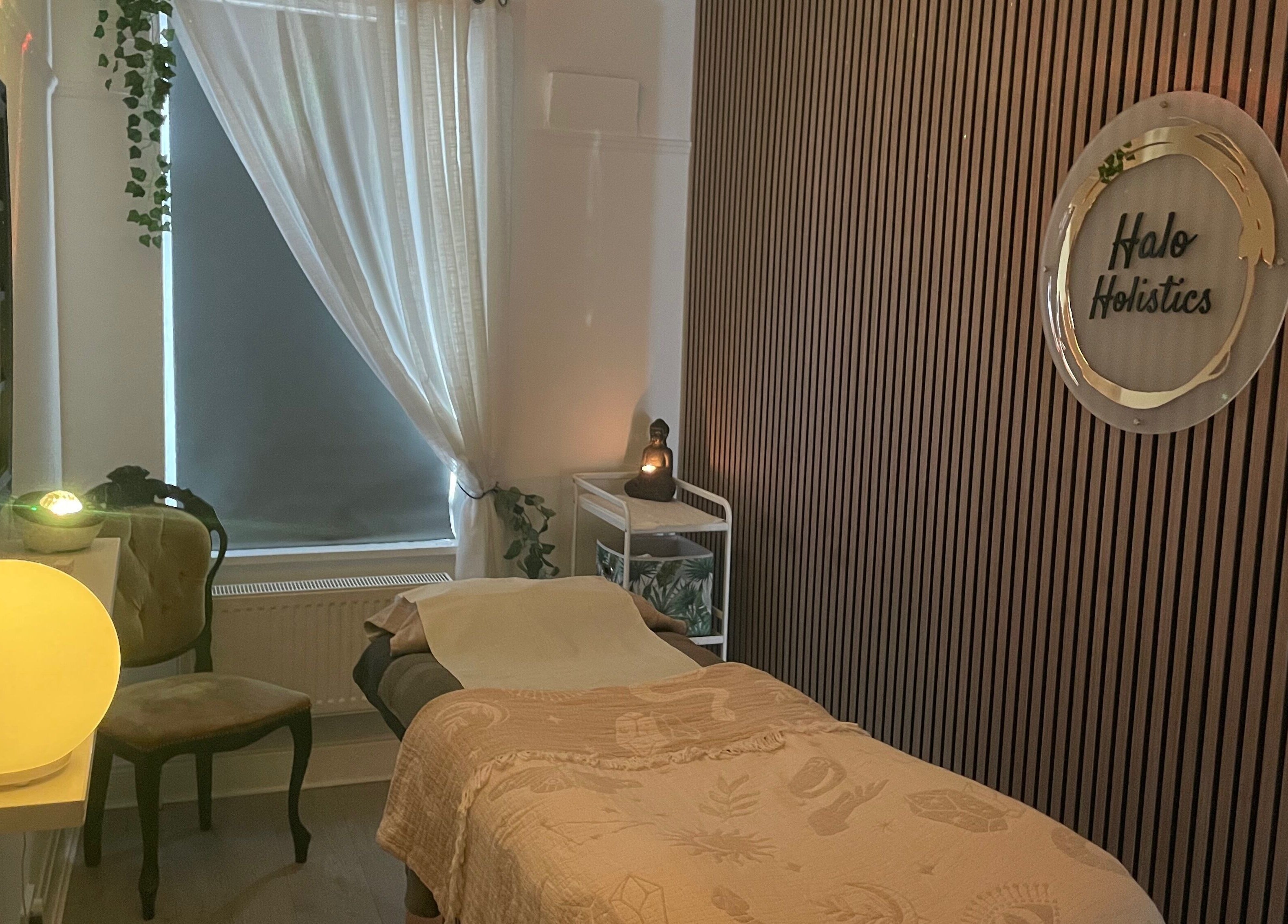 Cozy massage room at Halo Holistics in Perfection Lounge, Whiston, England, GB, featuring calming decor.