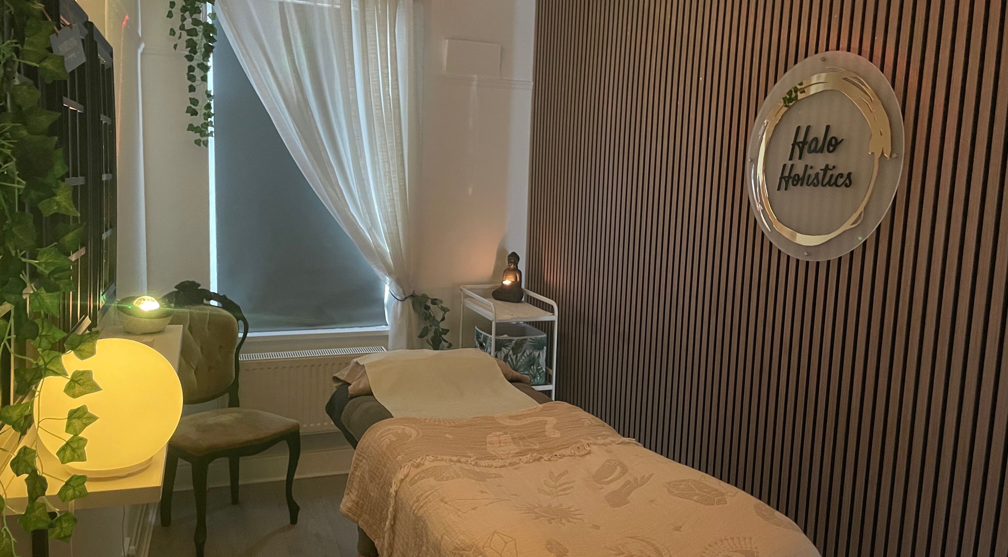 Cozy massage room at Halo Holistics in Perfection Lounge, Whiston, England, GB, featuring calming decor.