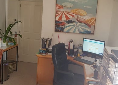 Cozy office space at Contour Studio Perth in Yokine, Western Australia, AU with desk, computer, and beach art.