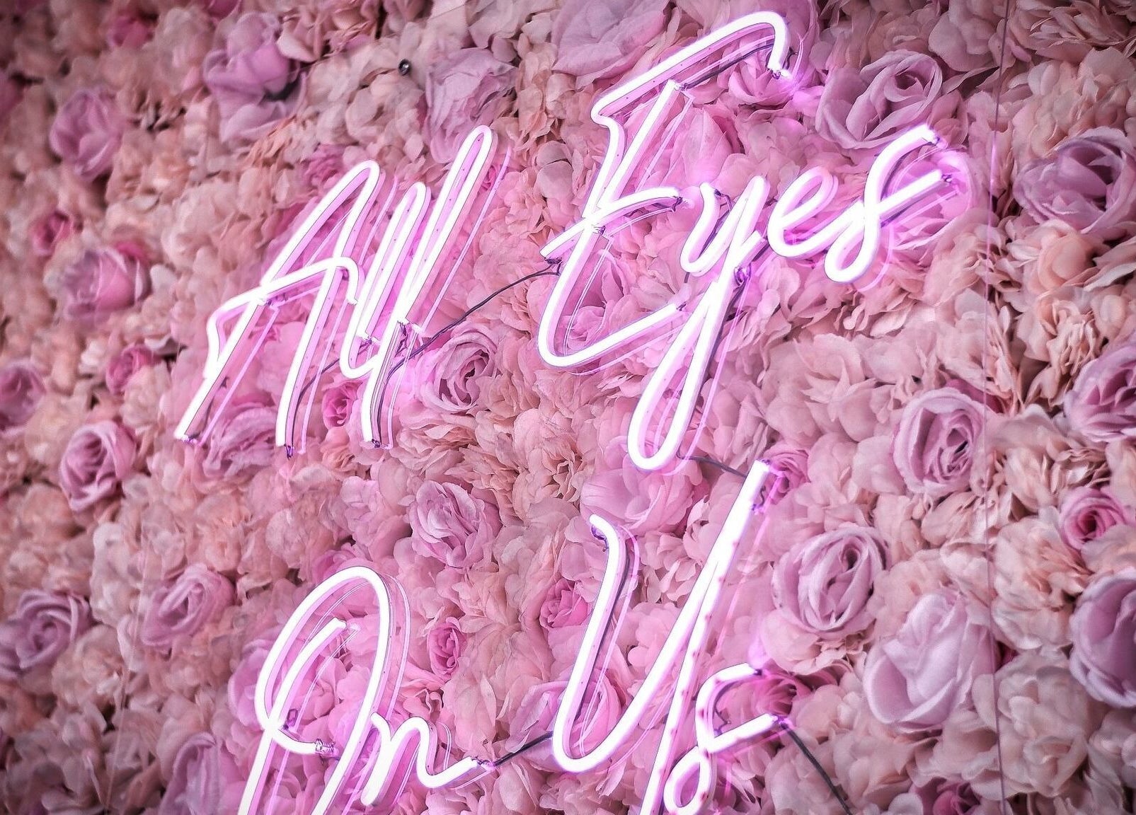 Neon sign 'All Eyes On Us' on floral wall at ELZYT, Drogheda, County Louth, IE.
