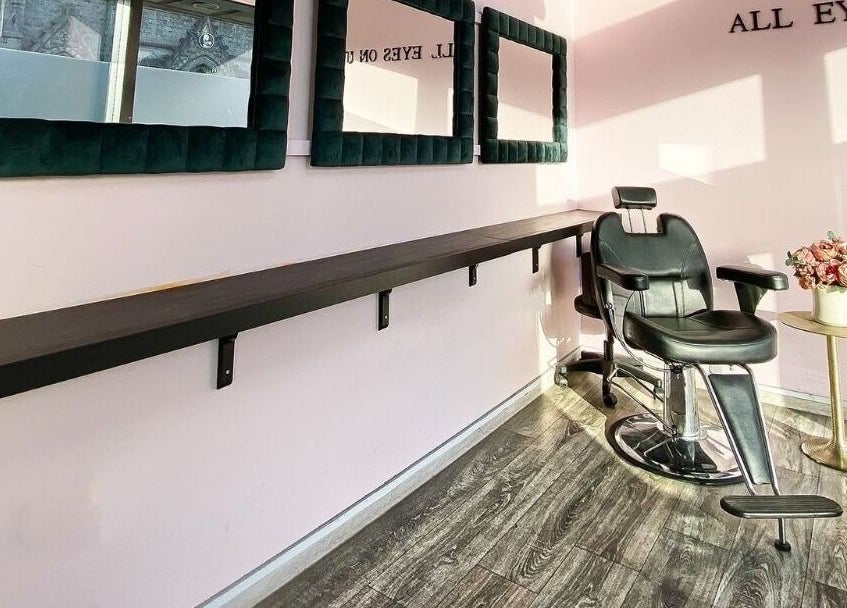 Stylish salon station at ELZYT, Drogheda, County Louth, IE with mirrors, chair, and floral decor.