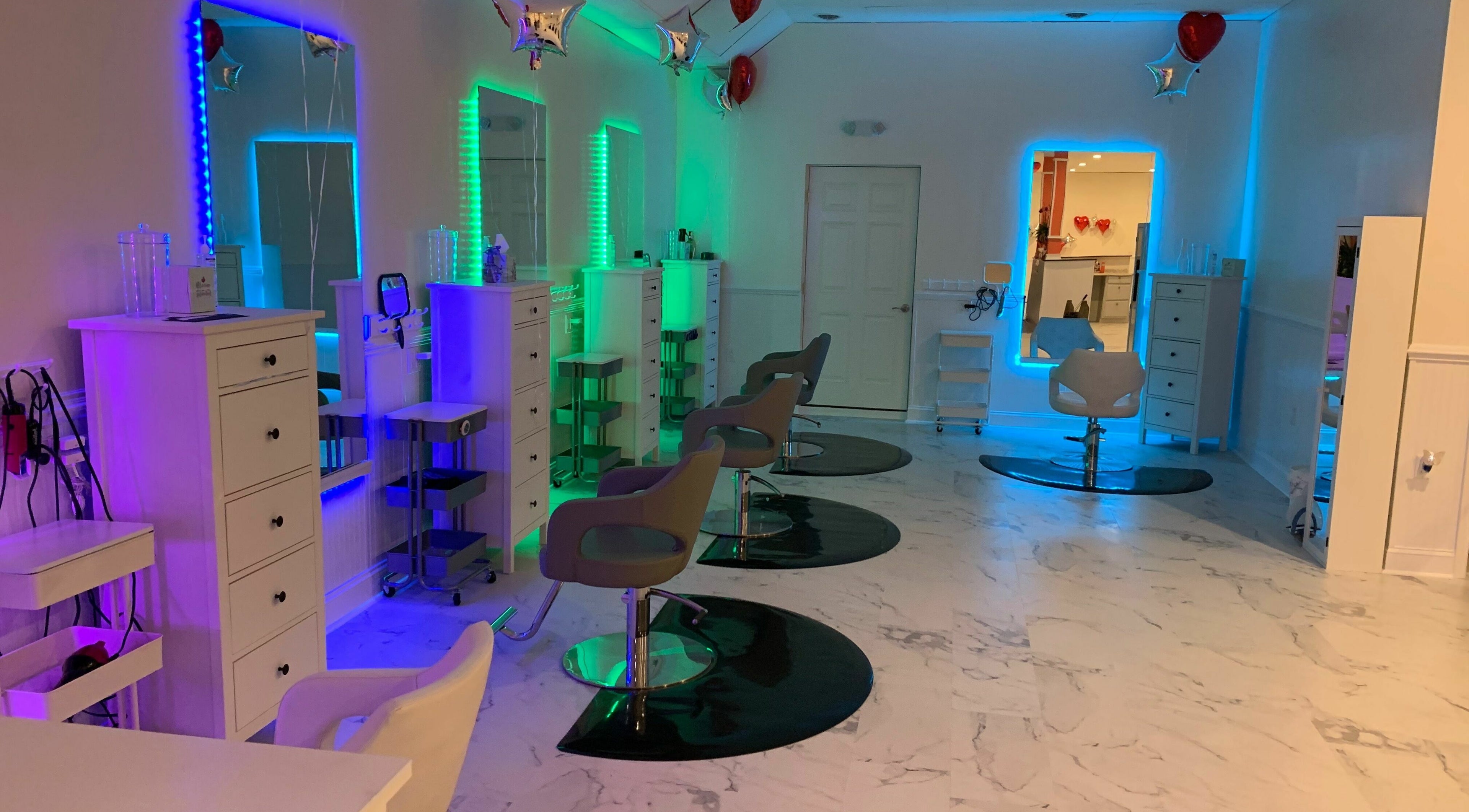 Chic beauty salon interior at Cevaluk, Waynesboro, Virginia, US, featuring colorful LED mirrors and styling chairs.