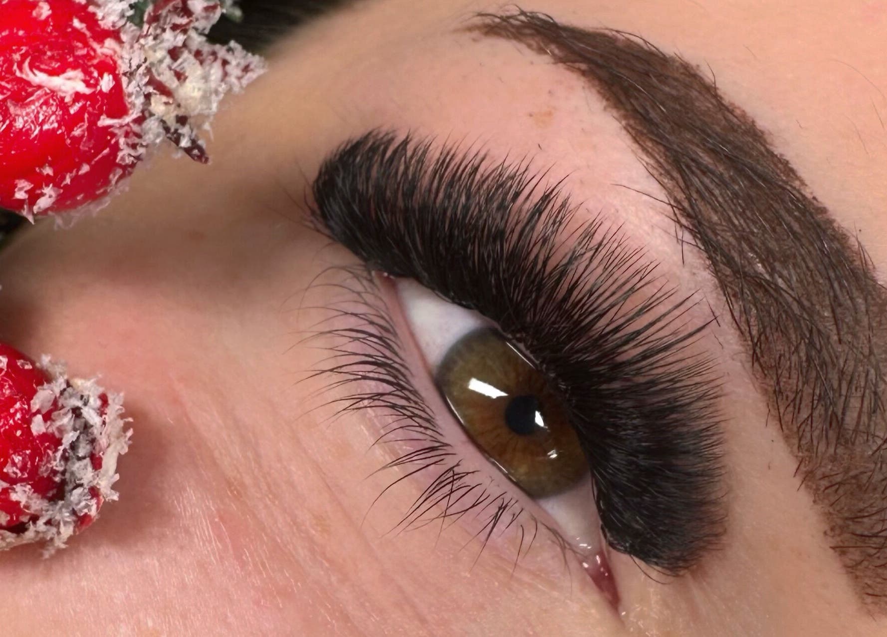 Close-up of eye with thick lashes at M.E Glam Room, Sutton-in-Ashfield, England, GB.