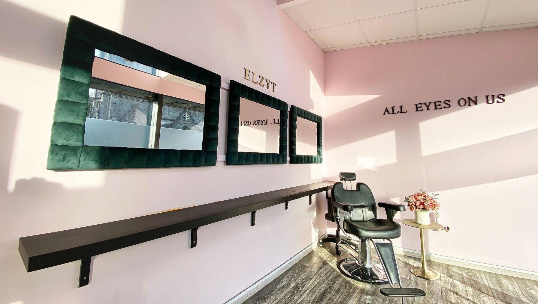 Elegant salon interior at Elzyt Salon Kristina in Drogheda, IE, featuring stylish mirrors and a modern chair.