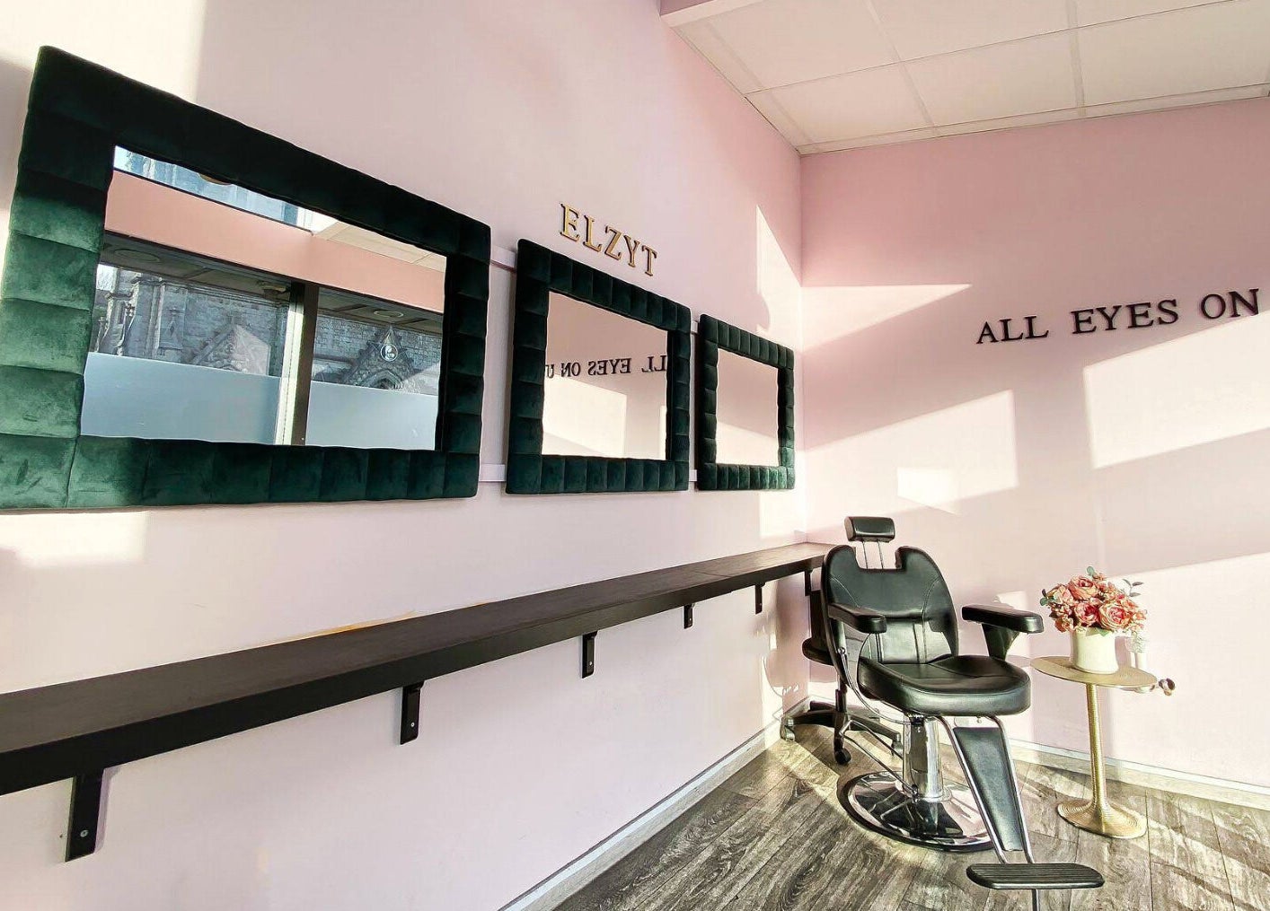Elegant salon interior at Elzyt Salon Kristina in Drogheda, IE, featuring stylish mirrors and a modern chair.