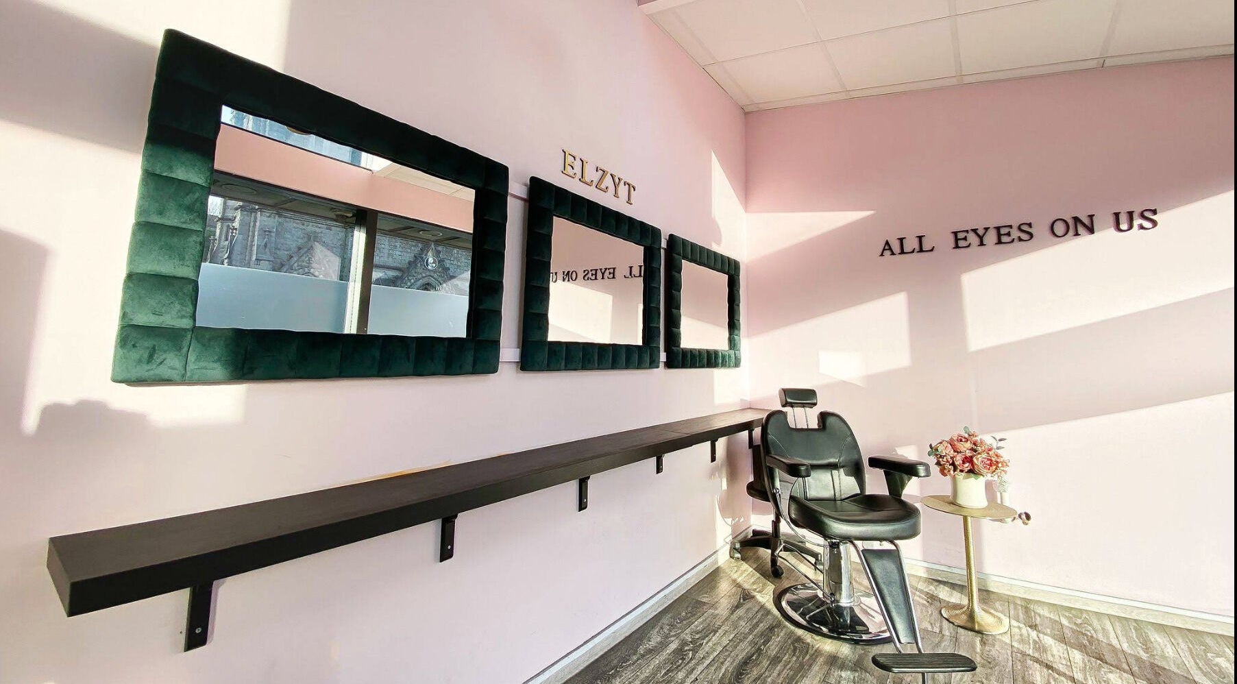 Elegant salon interior at Elzyt Salon Kristina in Drogheda, IE, featuring stylish mirrors and a modern chair.