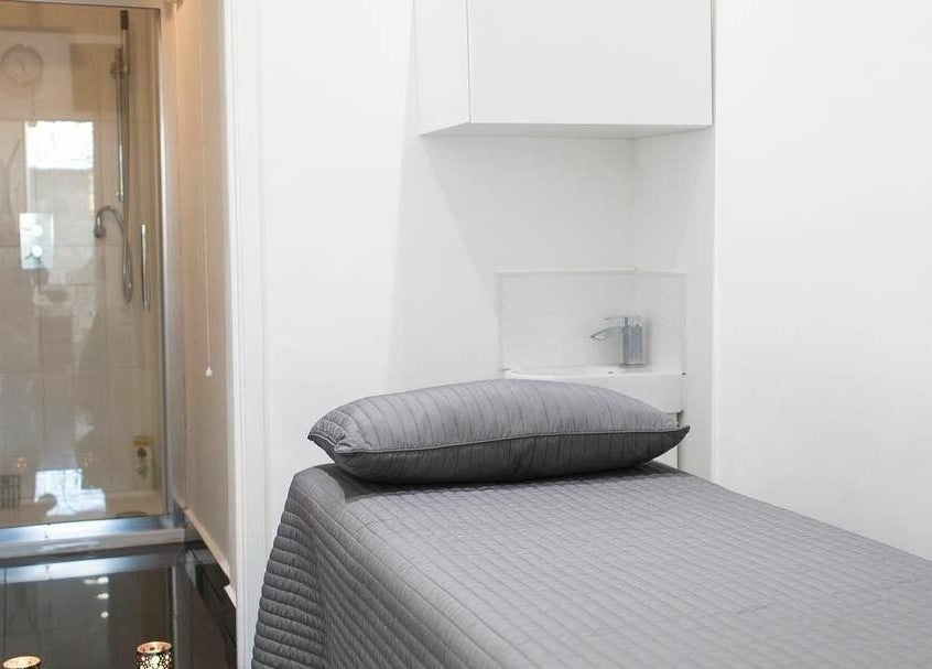 Relaxing spa room at Maxx Mira Clinic in Enfield, England, GB, featuring a comfortable massage bed and modern decor.