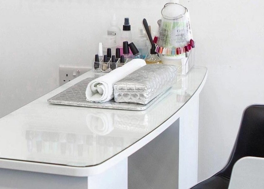 Modern nail station at Maxx Mira Clinic in Enfield, England, GB, featuring manicure tools and polishes.