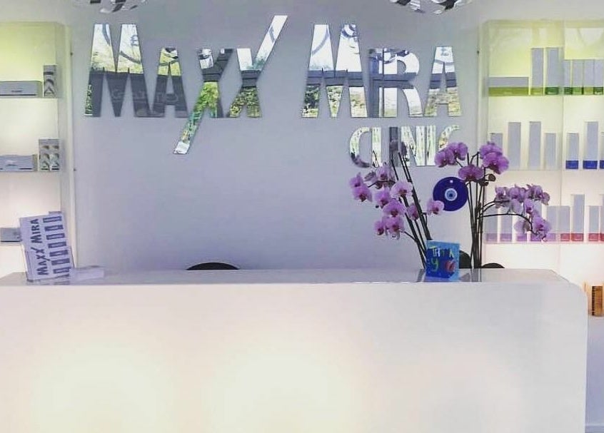 Front desk at Maxx Mira Clinic in Enfield, England, GB, featuring modern design and fresh orchids.