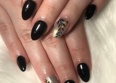 Elegant black and gold nail art at Tipsy Nail Bar, Daniels Parkway, Fort Myers, Florida, US.