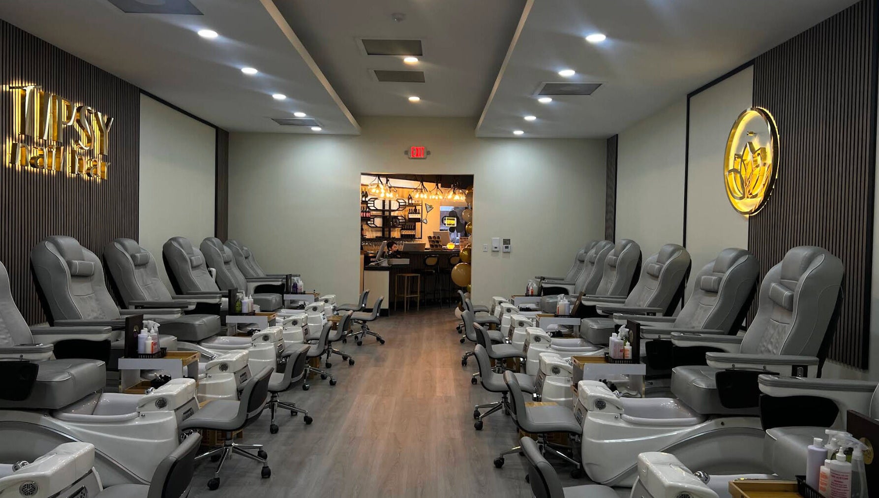 Interior of Tipsy Nail Bar, College Parkway in Fort Myers, Florida, US showcasing plush pedicure chairs.