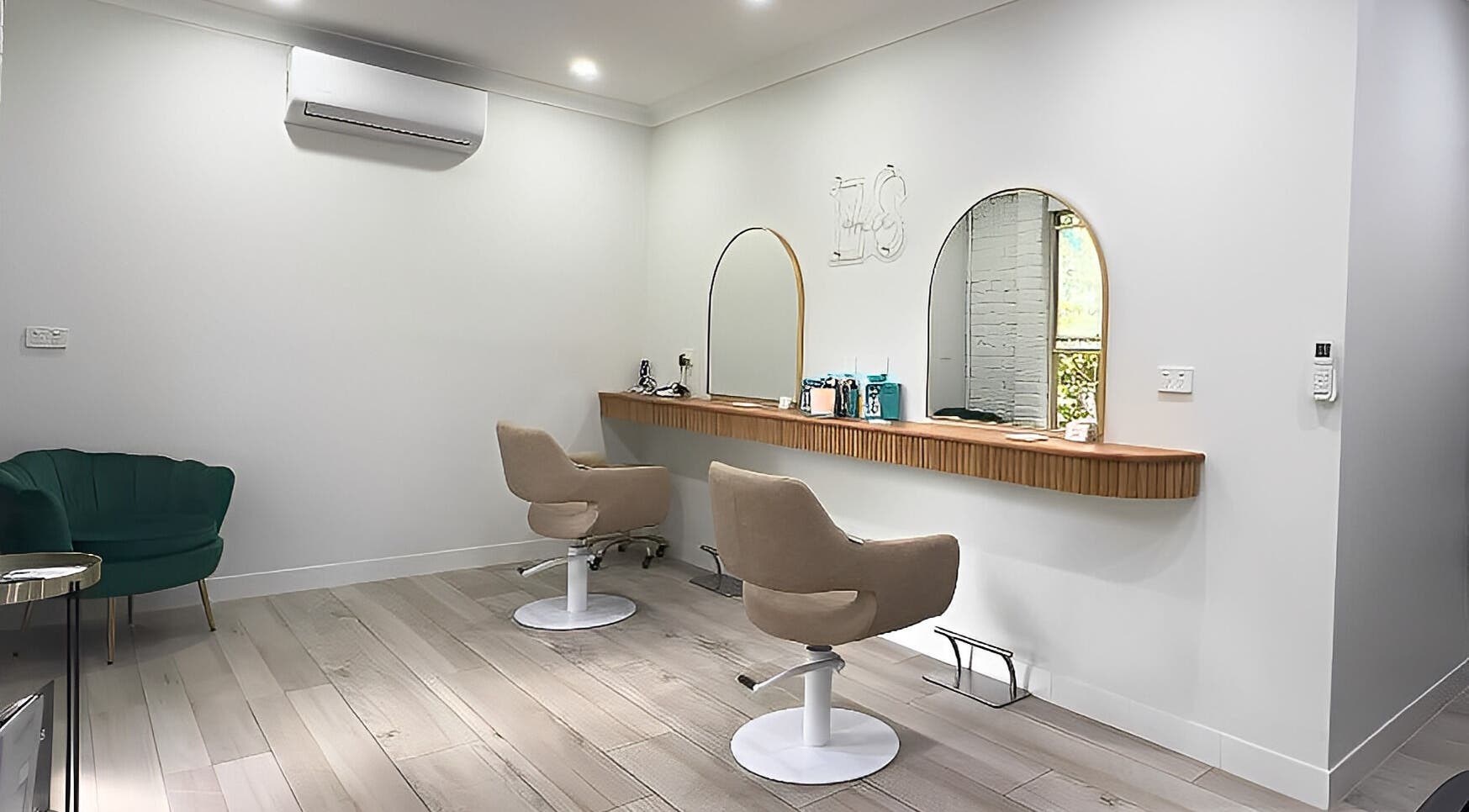 Modern salon interior at Erin Stevens Hair, Erskine Park, New South Wales, AU, featuring stylish seating and mirrors.