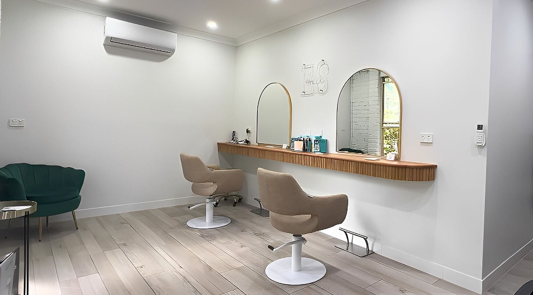 Modern salon interior at Erin Stevens Hair, Erskine Park, New South Wales, AU, featuring stylish seating and mirrors.