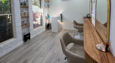 Stylish salon interior at Erin Stevens Hair, Erskine Park, New South Wales, AU, with elegant mirrors and plush chairs.