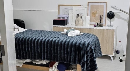 Sala de tratamento acolhedora na MF Skin D'Lux, Lisboa, Lisboa, PT, com móveis elegantes e decoração suave.