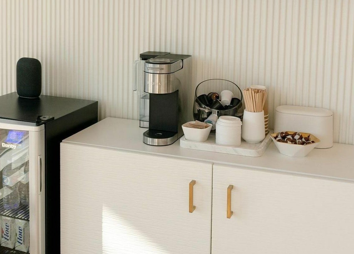 Refreshment area at Laser Bar, Barrie, Ontario, CA featuring a coffee maker, cups, and mini-fridge.