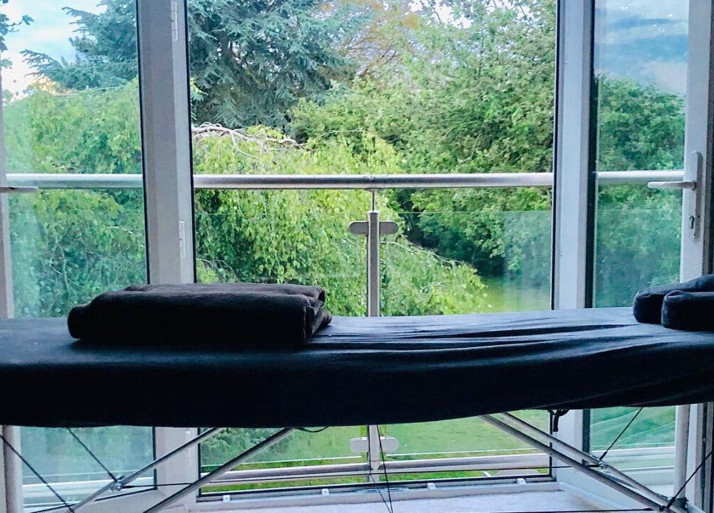 Massage table at Practically Perfect in Every Way, Tewin, England, GB with tranquil garden view.