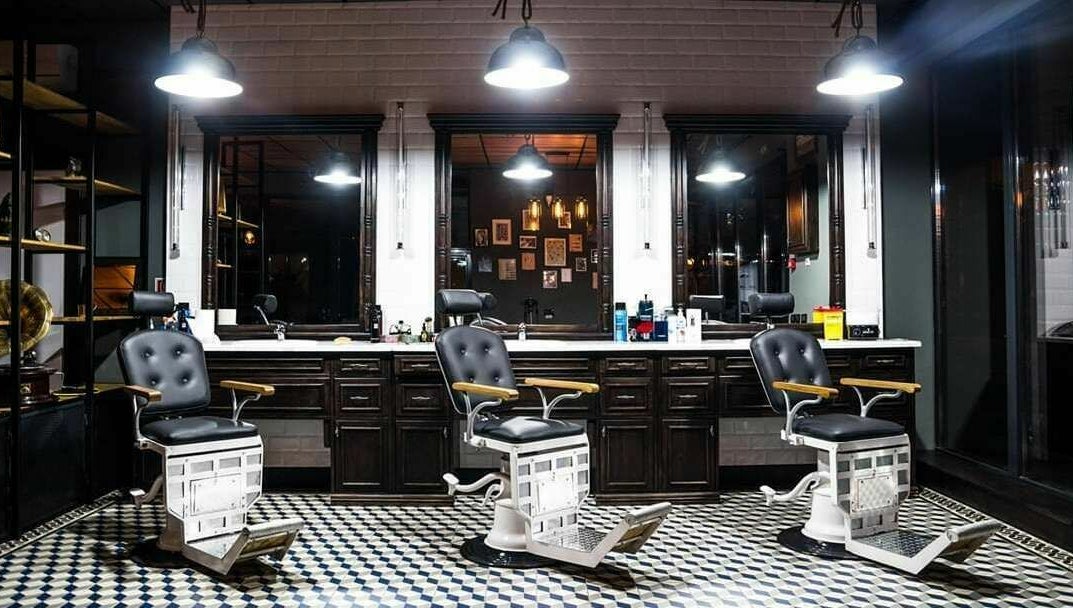Interior elegant la Barber Society, Cluj-Napoca, Județul Cluj, RO, cu scaune de barberie clasice și lumini calde.