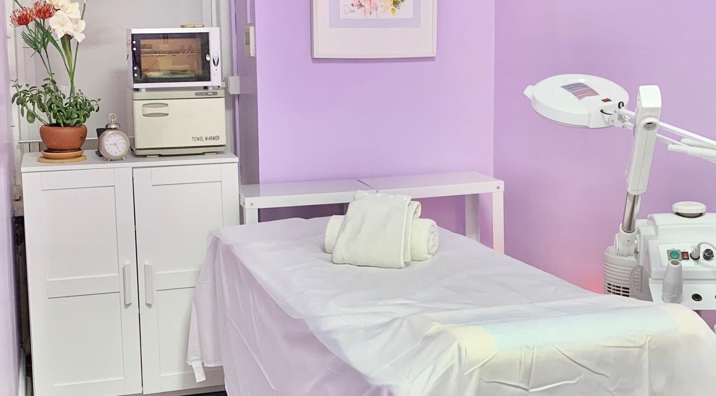 Tranquil treatment room at Le Bon Skin Lab in New York, New York, US with lilac walls and cozy setup.