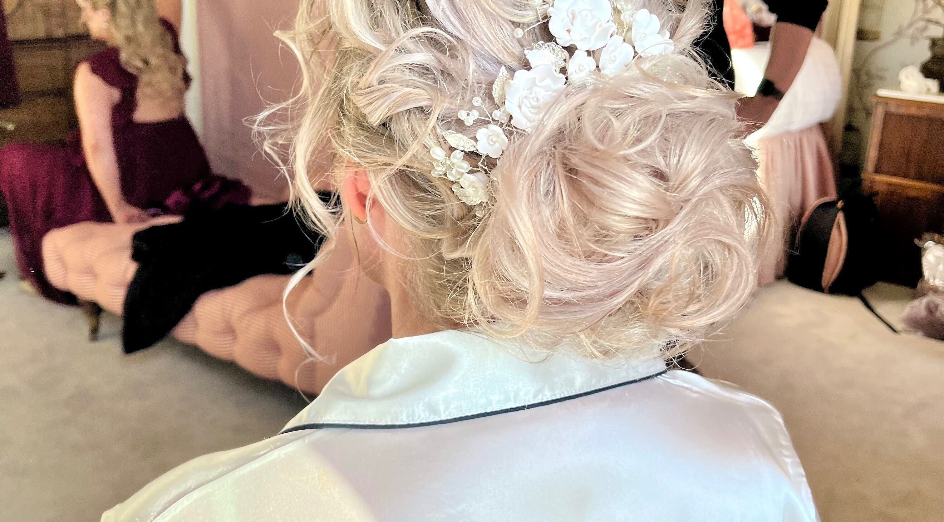 Intricate bridal hairstyle at Charlie’s Hair and Beauty, Eccleshall, England, GB, showcasing elegant floral details.