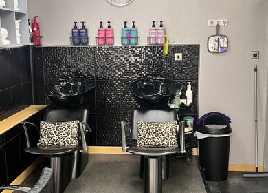 Luxurious wash station at Joanne at Jo Dazzle, Aberdeen, Scotland, GB with sleek black chairs and shampoo bottles.