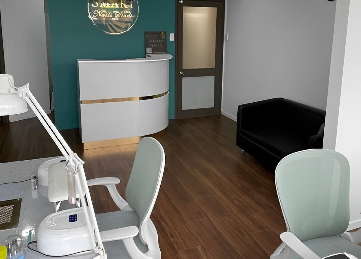 Interior of Smart Nails Studio in Auckland, NZ featuring a sleek reception and modern nail workstations.