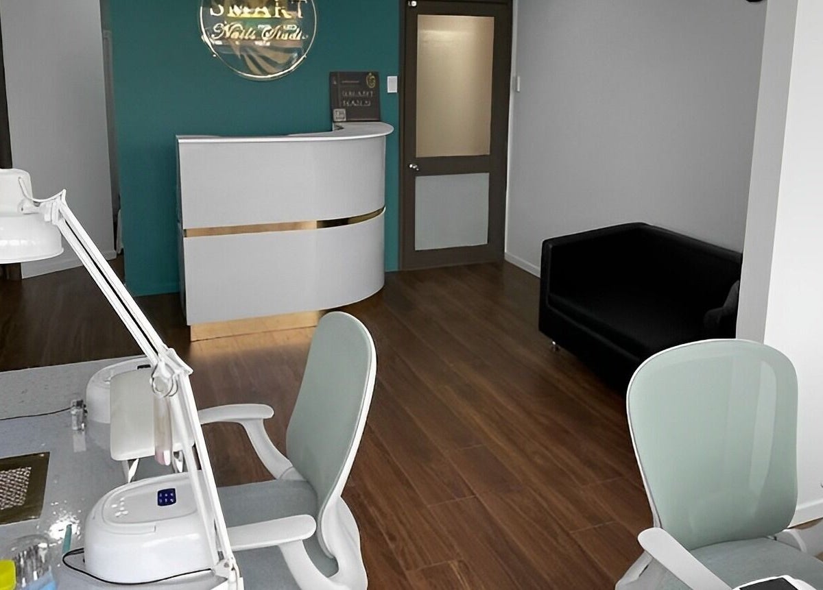 Interior of Smart Nails Studio in Auckland, NZ featuring a sleek reception and modern nail workstations.
