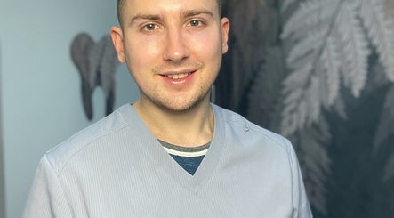 Professional at Confidence & Glow Aesthetics, Leeds, England, GB, smiling in a serene setting.