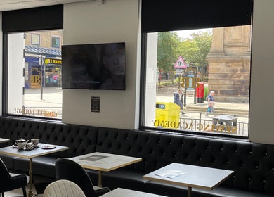Spacious seating with street view at Confidence & Glow Aesthetics, Morley, England, GB, inviting for relaxation.