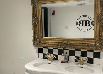 Luxurious vanity at Confidence & Glow Aesthetics, Morley, England, GB featuring ornate mirror and double sink.