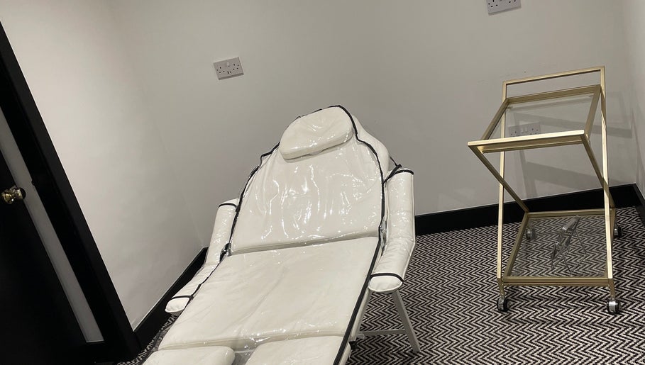 Luxurious treatment chair at Confidence & Glow Aesthetics, Morley, England, GB, with stylish decor.