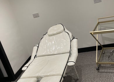 Luxurious treatment chair at Confidence & Glow Aesthetics, Morley, England, GB, with stylish decor.