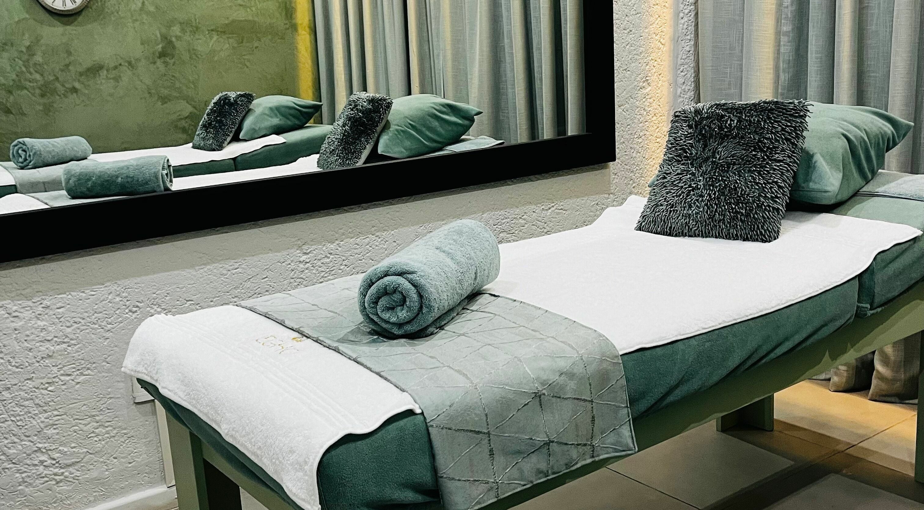 Relaxing spa room at Villa Africa Boutique Hotel, Pretoria, Gauteng, ZA with plush green linens and calming atmosphere.