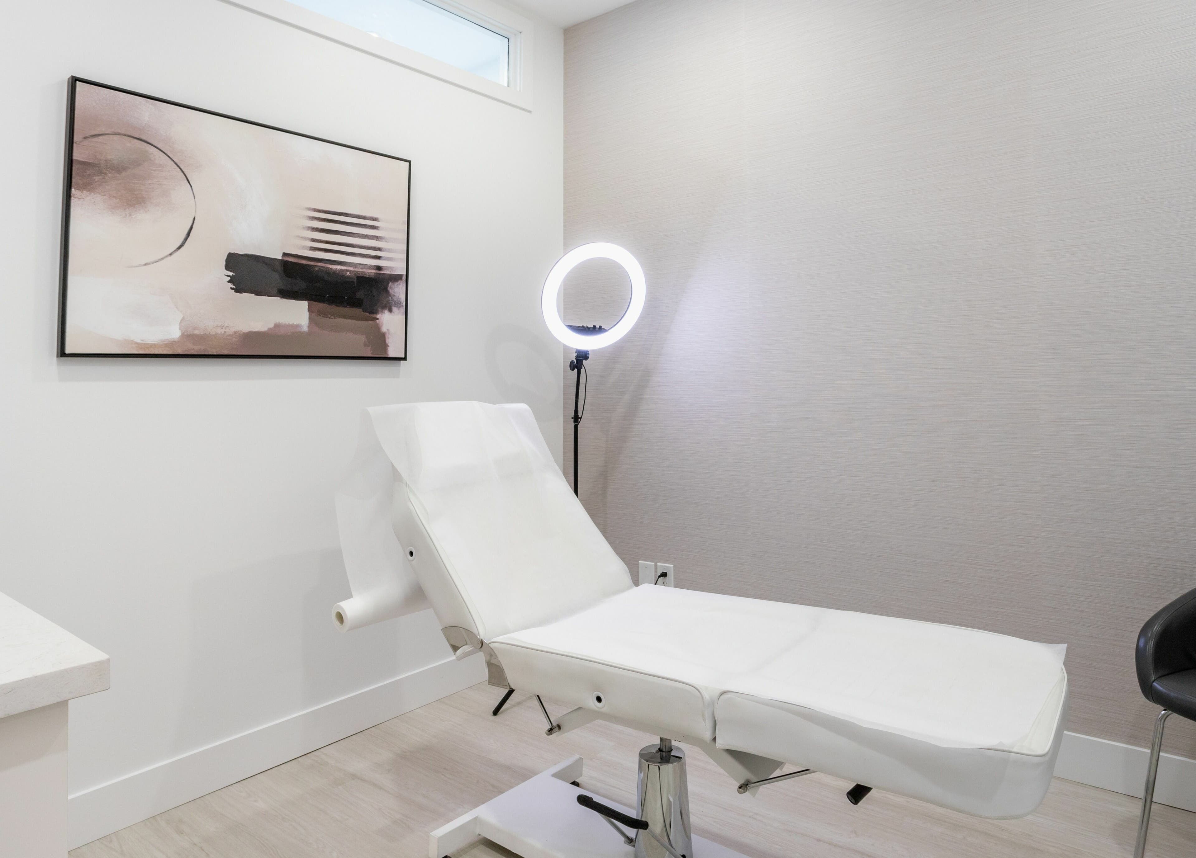 Elegant treatment room at MG Aesthetics, Vaughan, Ontario, CA, featuring a sleek bed and modern decor.