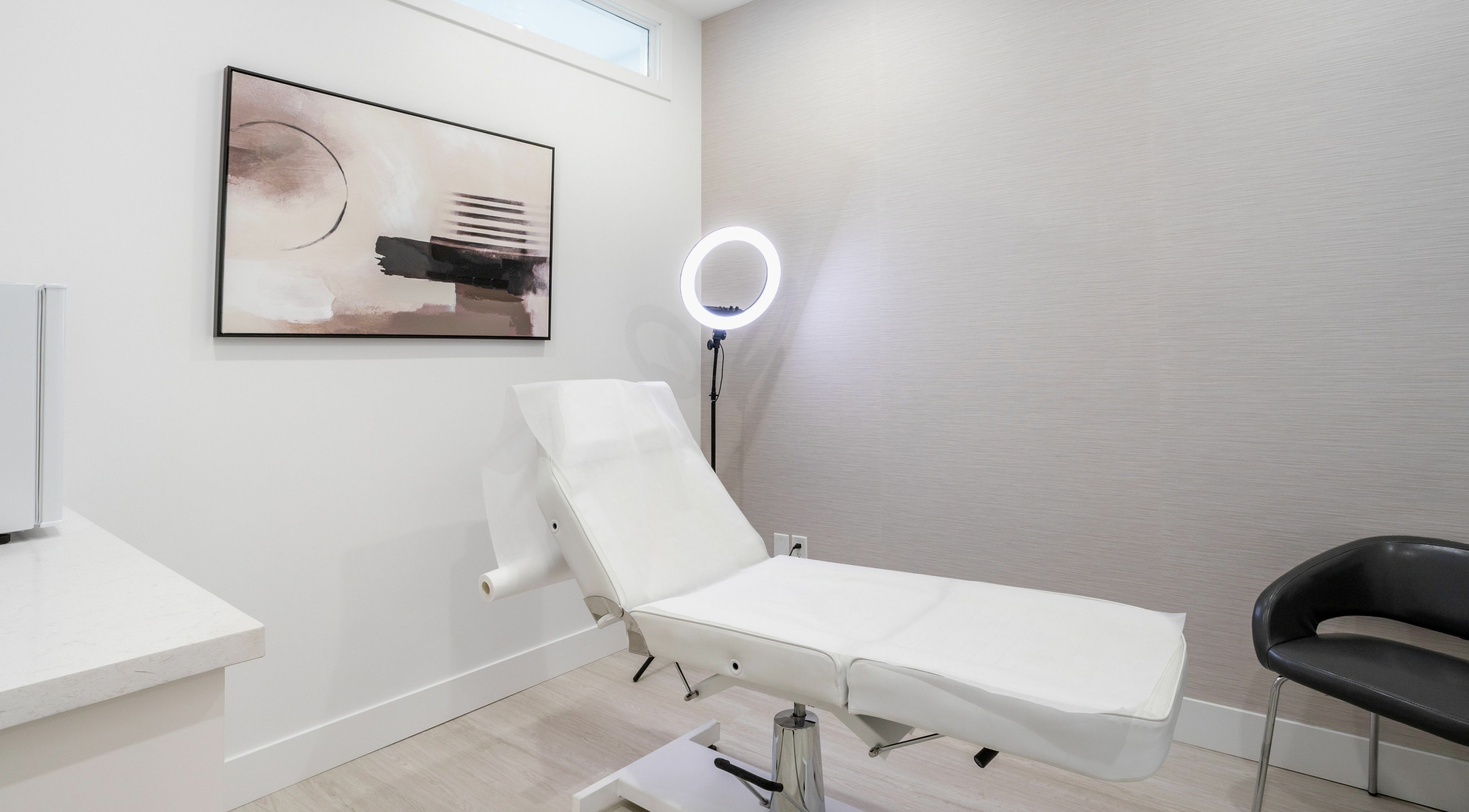Elegant treatment room at MG Aesthetics, Vaughan, Ontario, CA, featuring a sleek bed and modern decor.