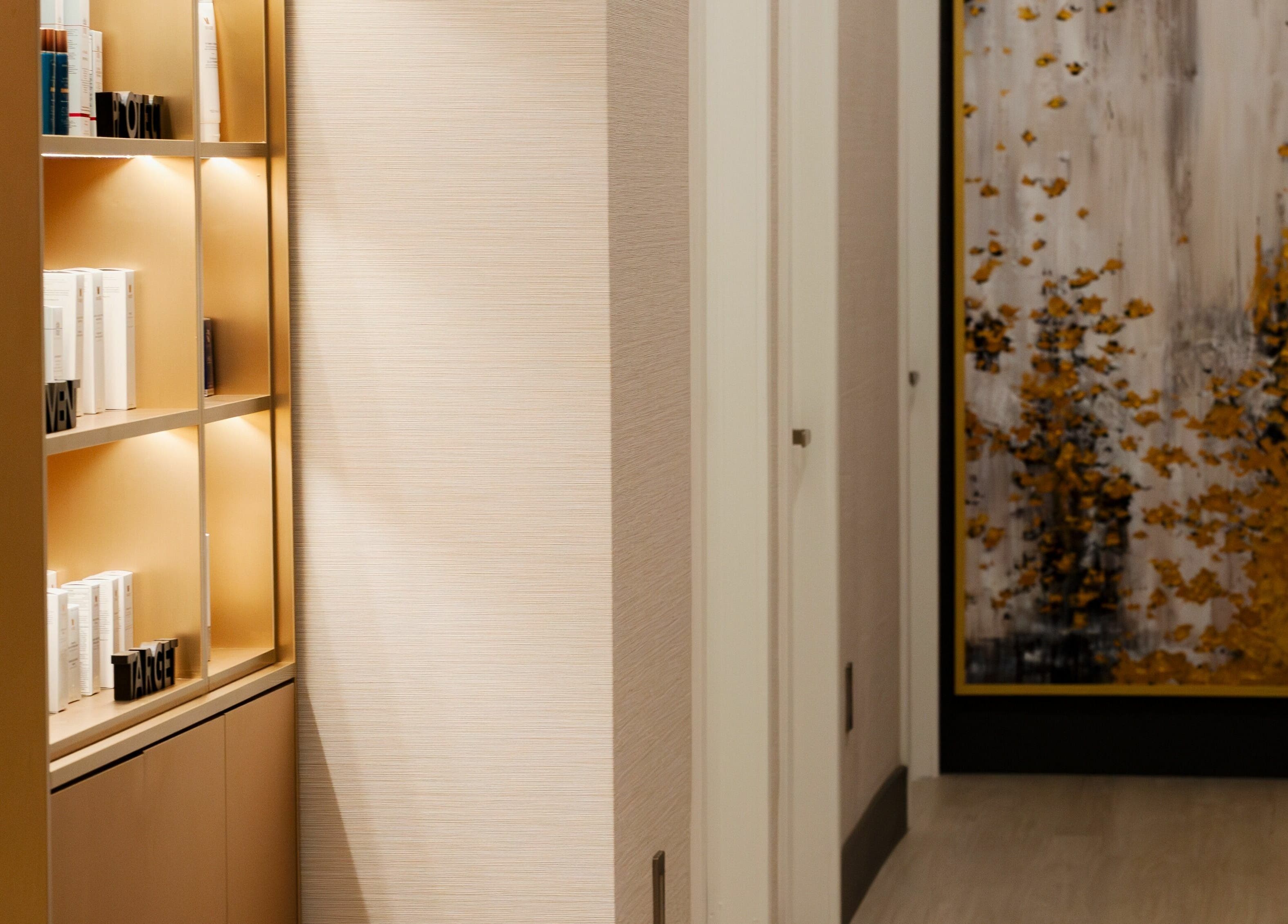 Elegant hallway and product shelf at MG Aesthetics, Vaughan, Ontario, CA, featuring a modern art piece.