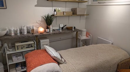 Cozy treatment room at Nature's Temple Beauty, Sudbury, England, GB with warm lighting and soft bedding.